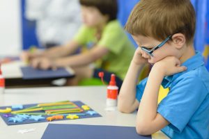 Angry,kid,looking,at,his,craft,at,kindergarten