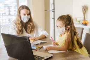 Student,girl,and,teacher,with,medical,mask,on,face,at