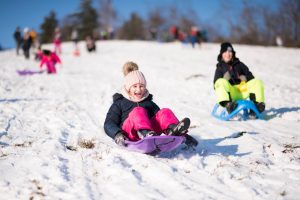 little,girl,sliding,with,bob,and,falling,in,the,snow.