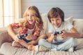 pretty,little,girl,and,boy,are,playing,game,console,and