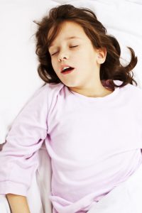 beautiful,little,girl,sleeping,with,her,mouth,open,,snoring.,studio