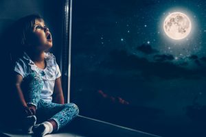 the,child,looks,out,the,window,into,the,night,sky