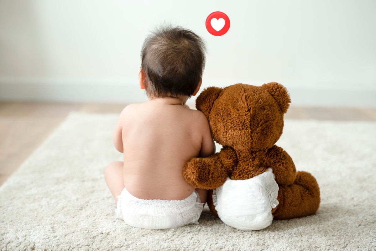 toddler,sitting,beside,his,teddy,bear