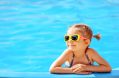 smiling,cute,little,girl,in,sunglasses,in,pool,in,sunny