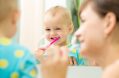 mother,and,kid,girl,look,at,mirror,during,teeth,brushing