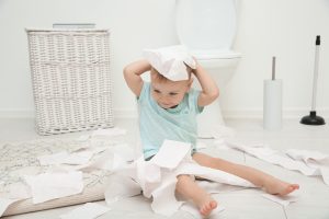 cute,toddler,playing,with,toilet,paper,in,bathroom