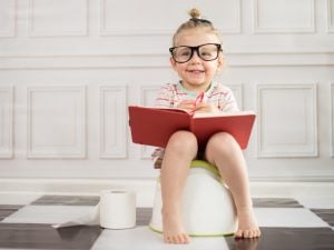 baby,girl,on,potty,with,notebook