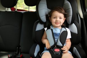 boy,sitting,in,a,car,in,safety,chair