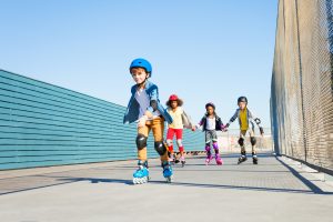 boy,playing,roller,skates,with,friends,outdoors