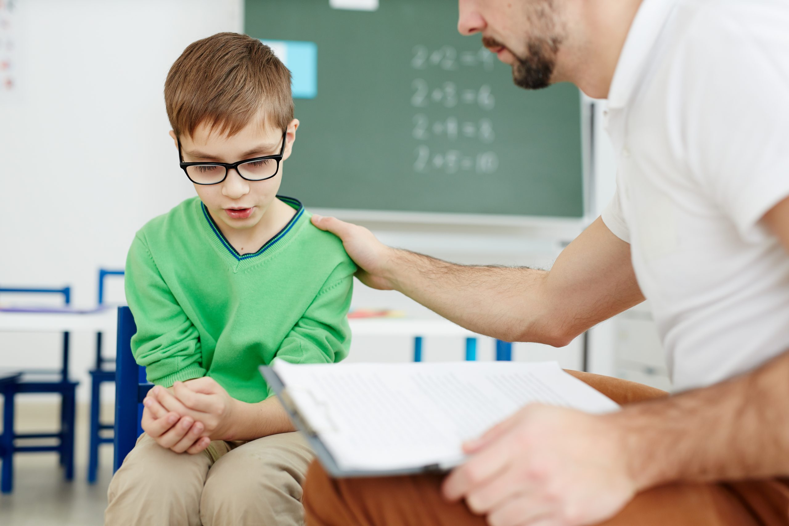 teacher,supporting,upset,or,confused,schoolboy,during,individual,lesson